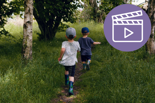 Two boys running through the grass with Adopt Coast to Coast video icon on image