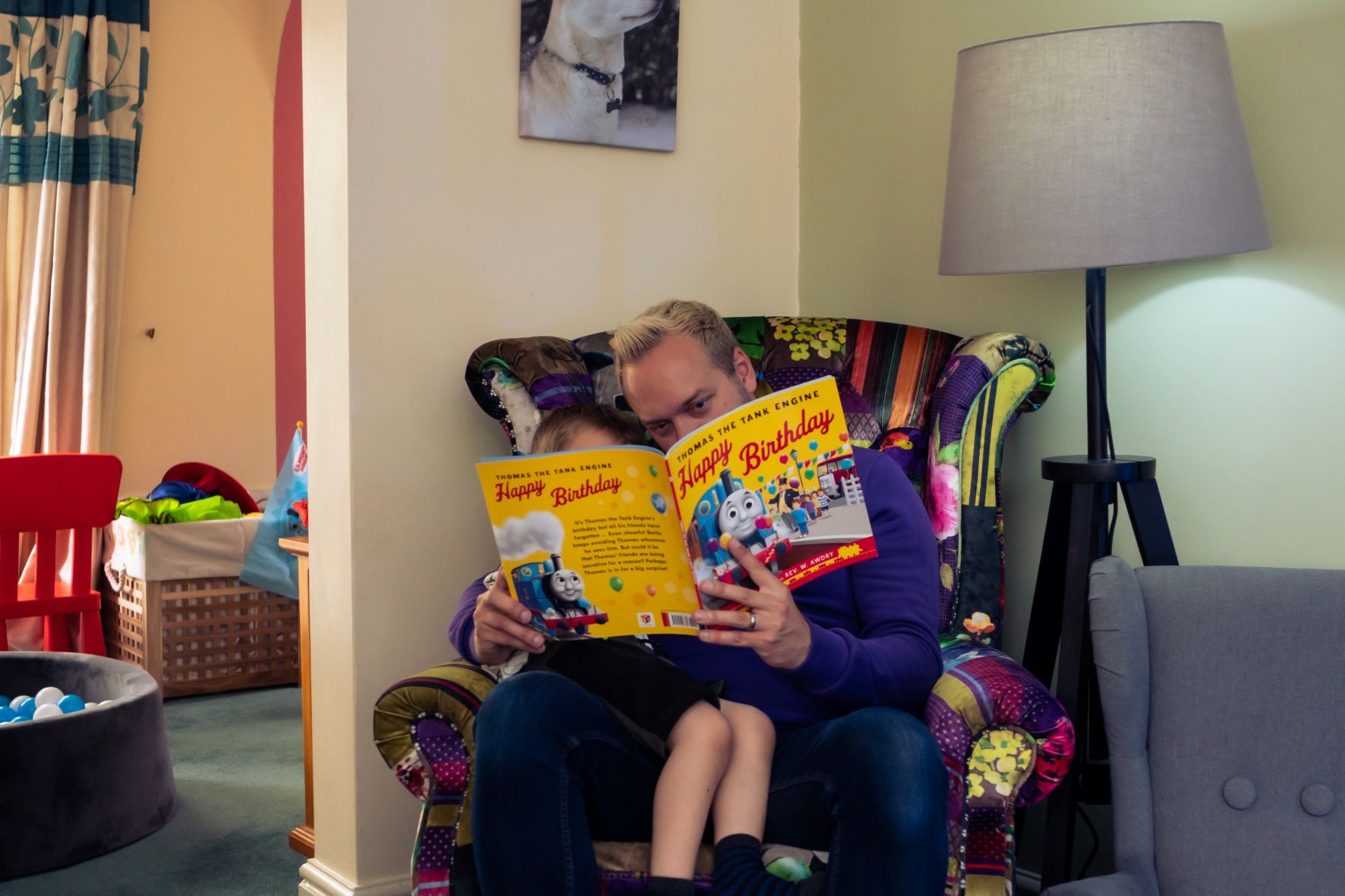 Dad Andy reading a book with his son