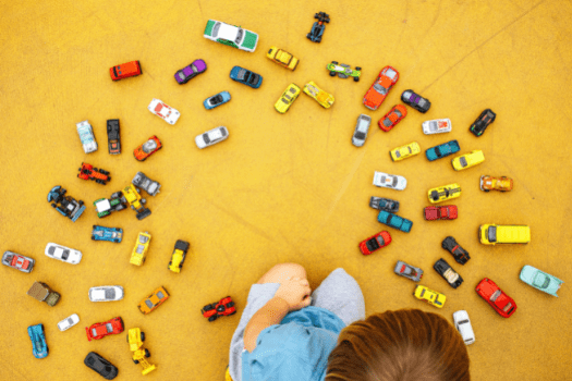 Little boy playing with cars