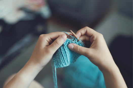 Lady knitting blue jumper
