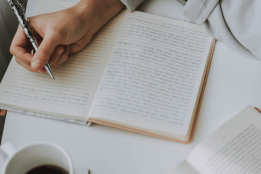 Woman writing notes in a book