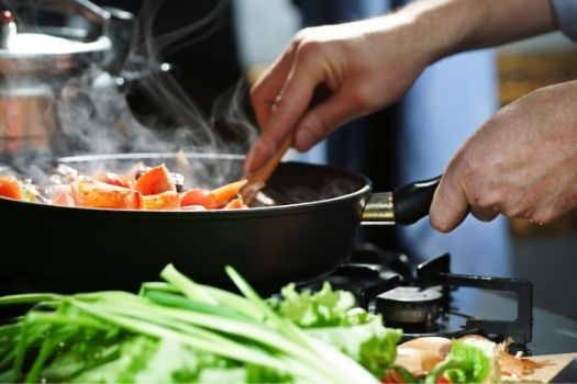 Man cooking with frying pan