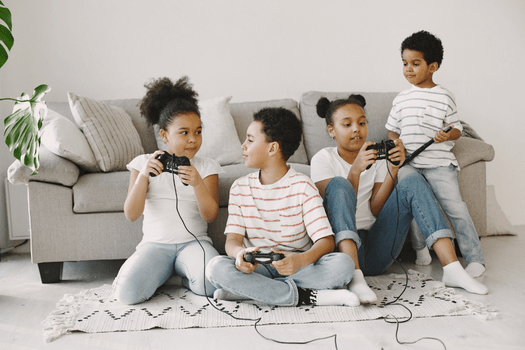 Four siblings playing computer games