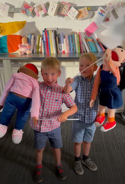Twin boys playing with puppets