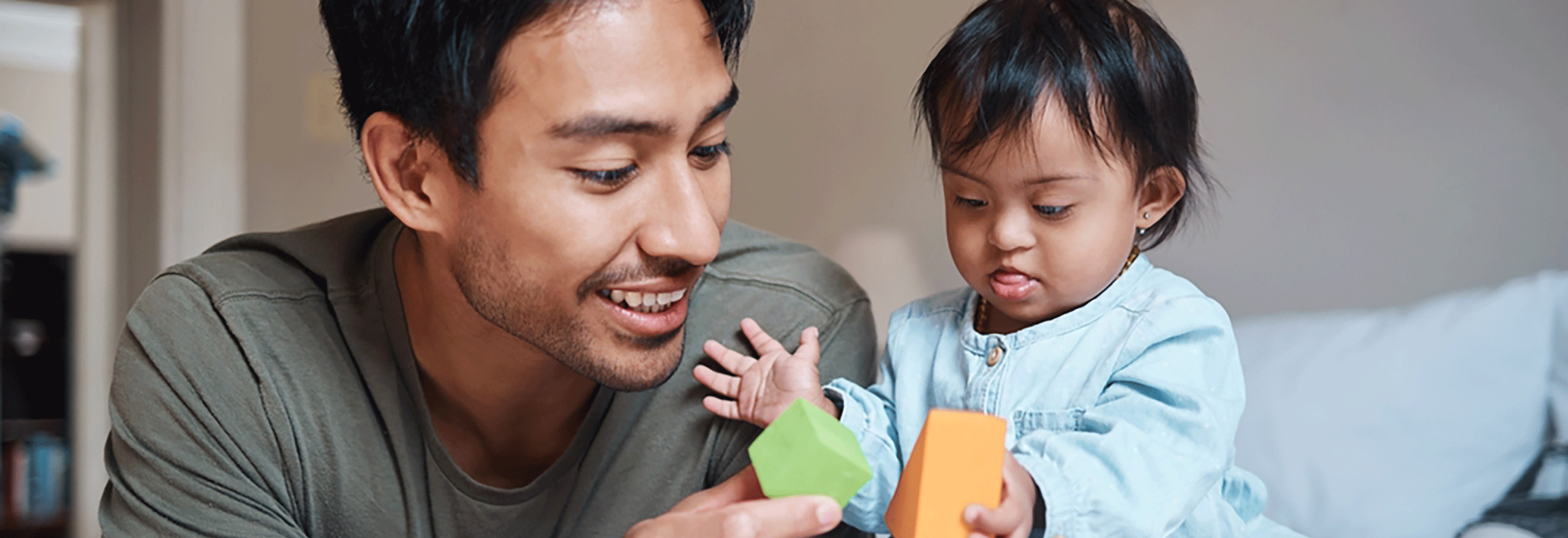 Man and child playing with building blocks