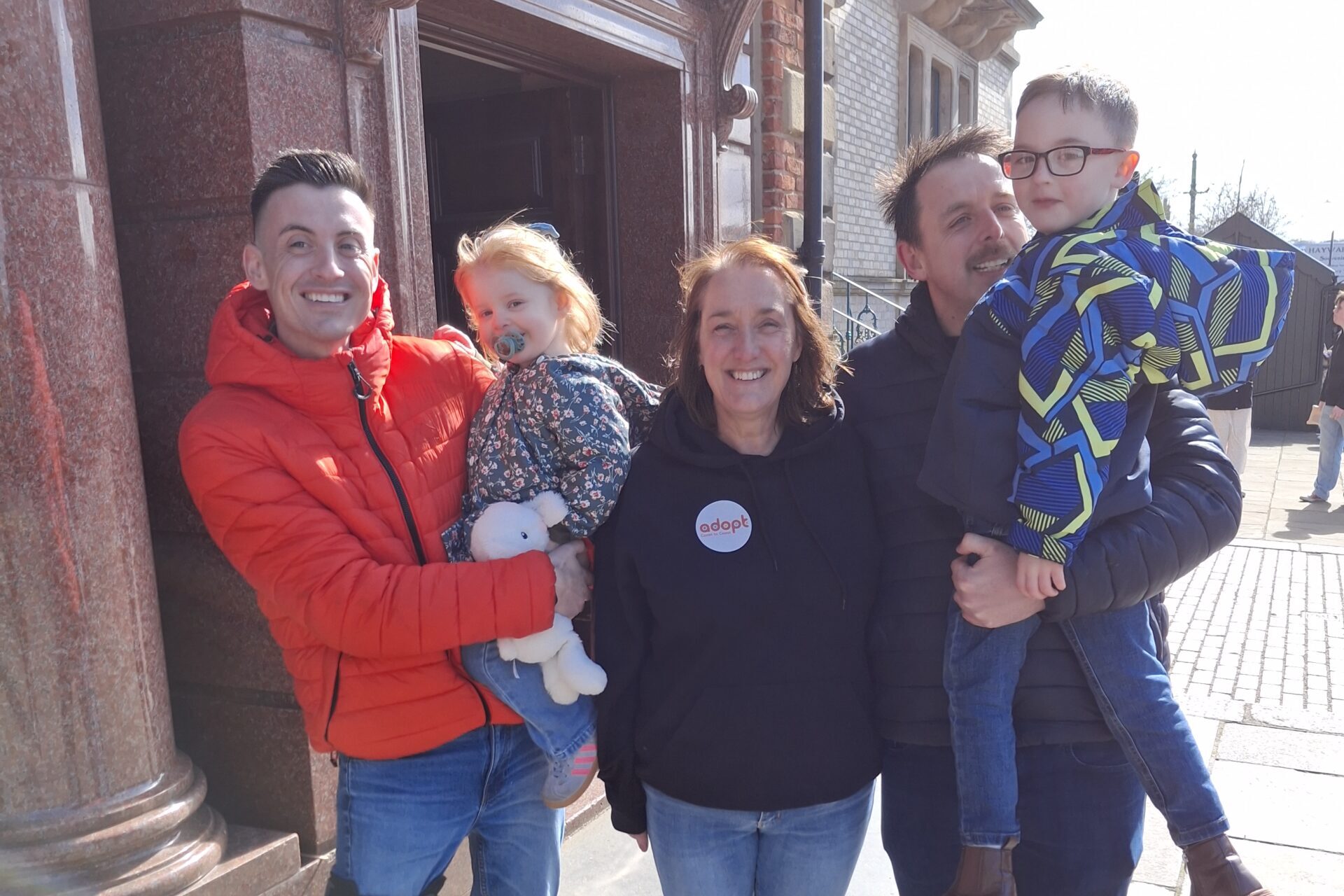 Three adults with two children